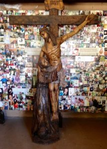 An unusual crucifix on the Chimayo grounds: note that Christ is shown with one arm reaching down from the cross to 